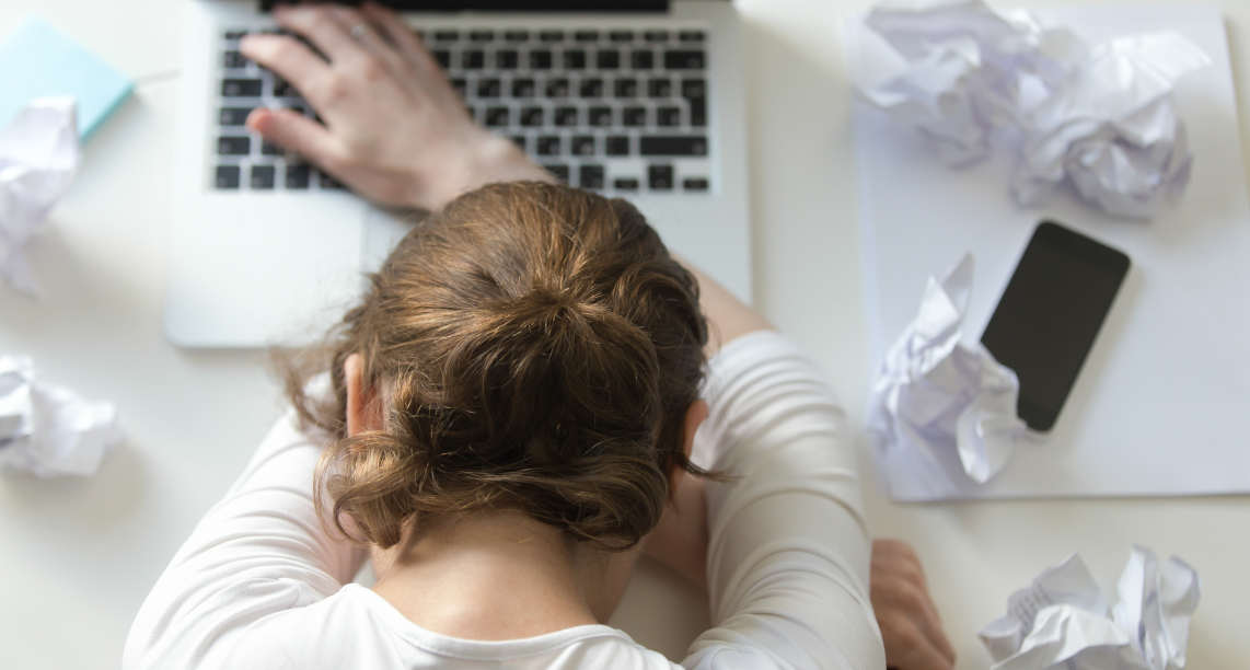 Top view portrait of woman lying at desk near the laptop