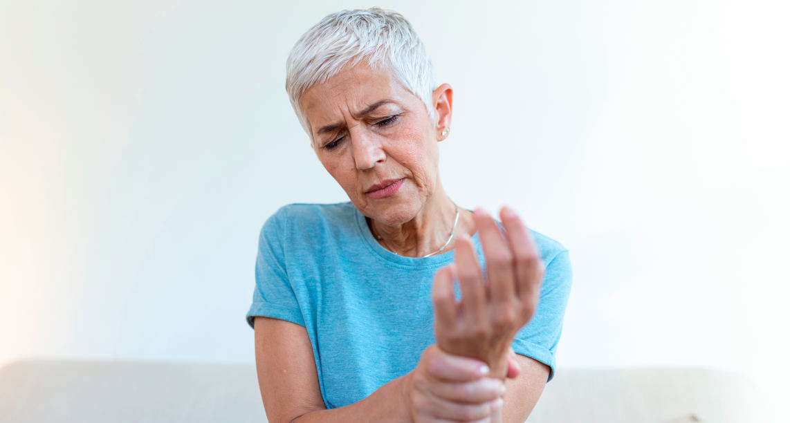 Elderly woman suffering from pain in hand, arthritis old person and senior woman female suffering from pain at home