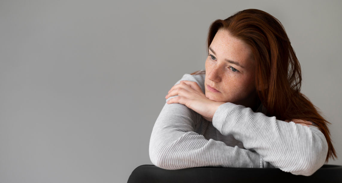 medium-shot-depressed-woman-sitting-on-chair